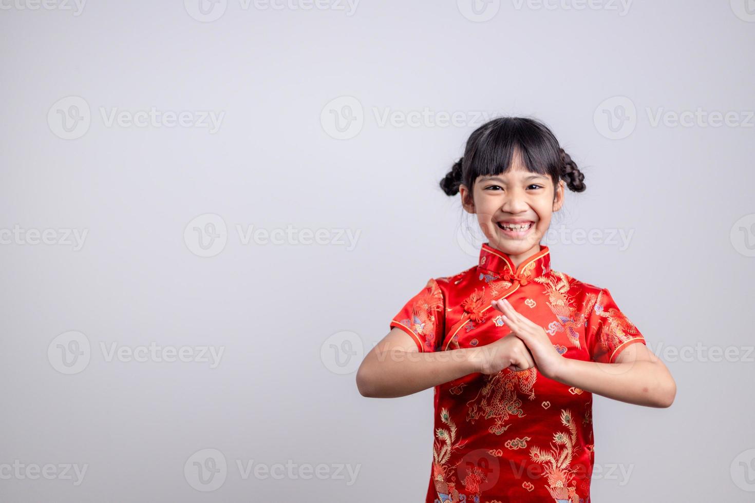 happy Chinese new year. Little Asian girls with Congratulation gesture photo