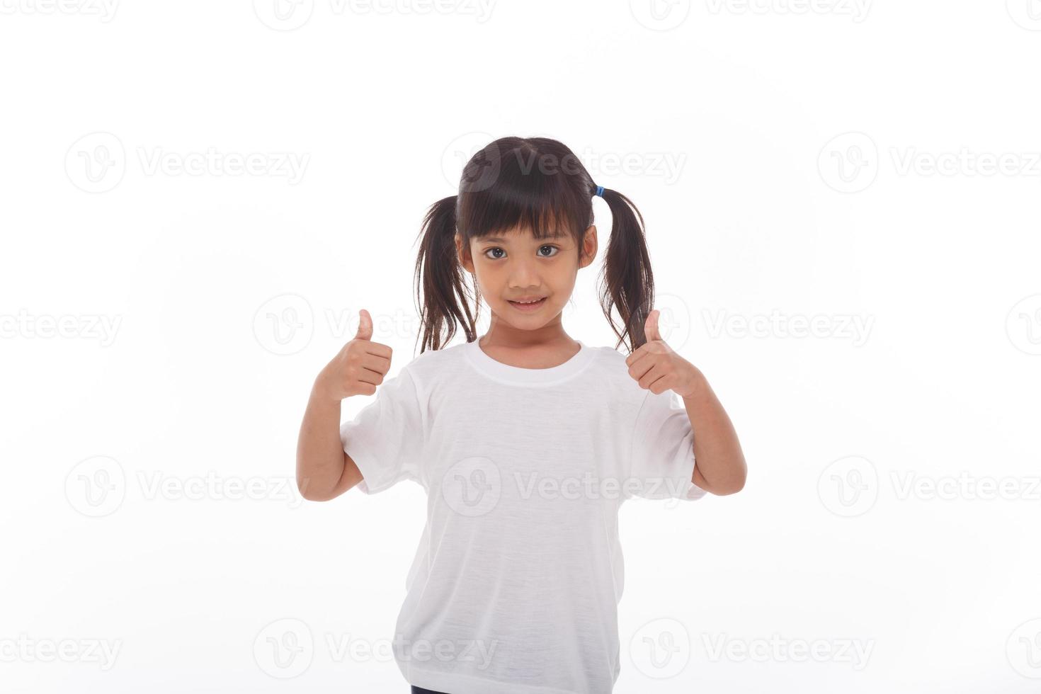 Little asian girl wearing mask for protect pm2.5 and show thumbs up gesture for good air outdoor.Air pollution pm2.5 and Coronavirus concept photo