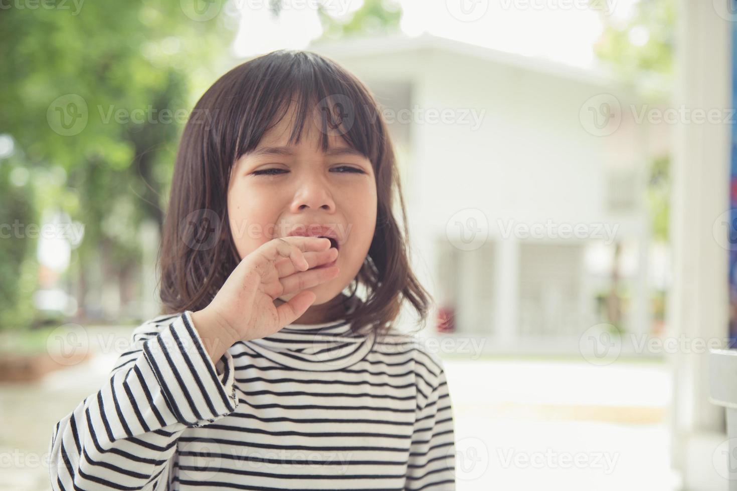 Portrait of Asian crying little girl with little rolling tears weeping emotion, hurt in pain fit drops cheek. Young crying panic drama Asian toddler. photo
