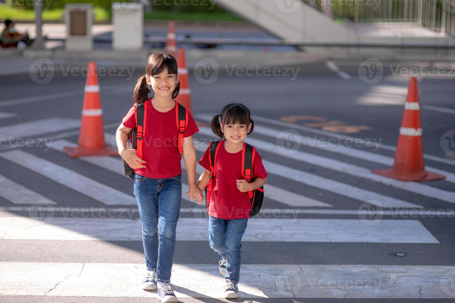 School child wearing a face mask during coronavirus and flu outbreak. sibling girl going back to school after covid-19 quarantine and lockdown. Kids in masks for coronavirus prevention.Soft Focus photo