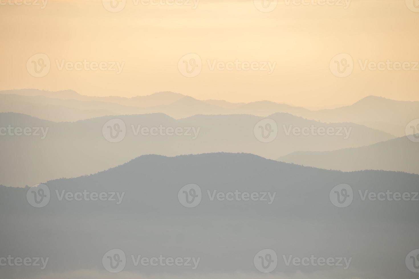 Layer of mountains and mist during sunset photo
