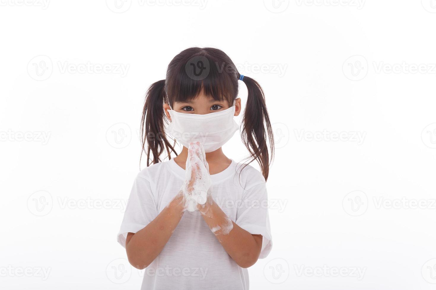 child washing hands and showing soapy palms.on white background photo