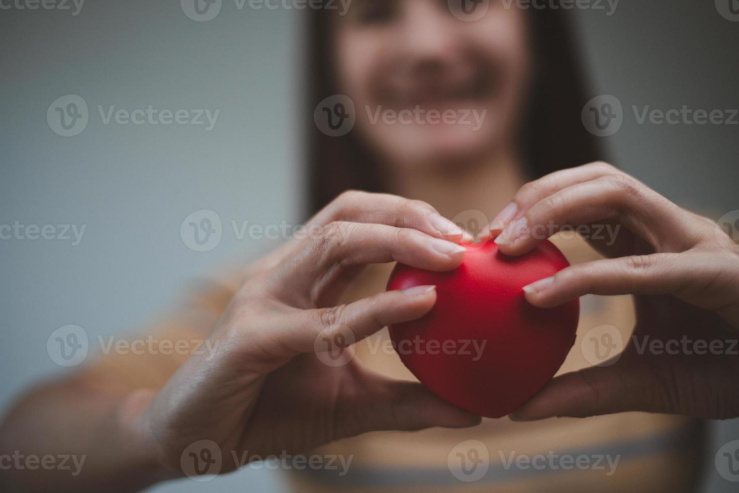 female hands holding red heart, world mental health day and world heart day, Life and health insurance, CSR social responsibility, organ donation photo