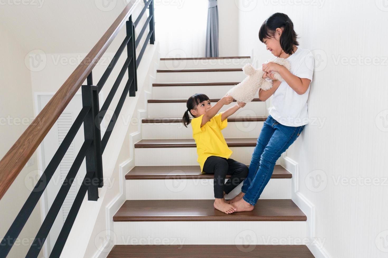 two little girl fighting over bear photo