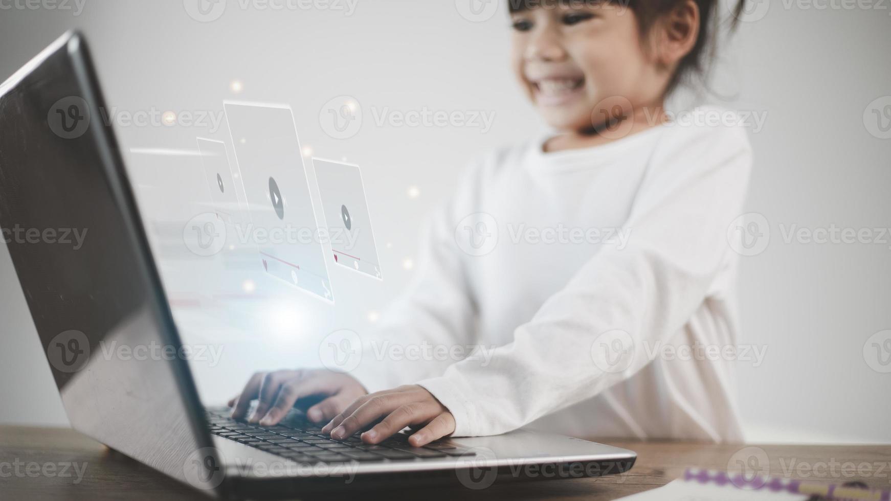 Asian girl using laptop for streaming online, watching video on internet, live study, tutorial, online learning, education, homeschooling. during Covid-19 pandemic lockdown. photo