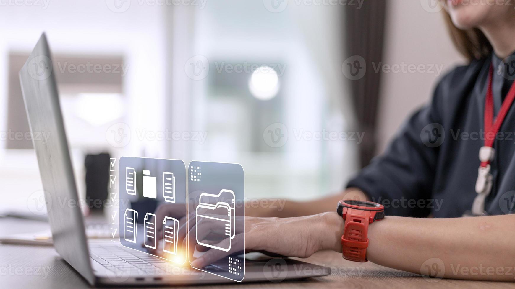 Document Management System DMS being setup by IT consultant working on laptop computer in office. Software for archiving, searching and managing corporate files and information photo