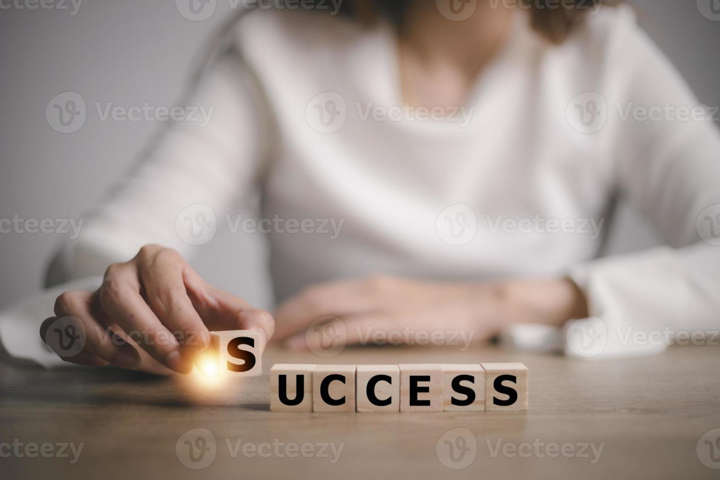 Businesswoman and wooden blocks with the word SUCCESS. Success must be based on strong pillars, achieving success. photo