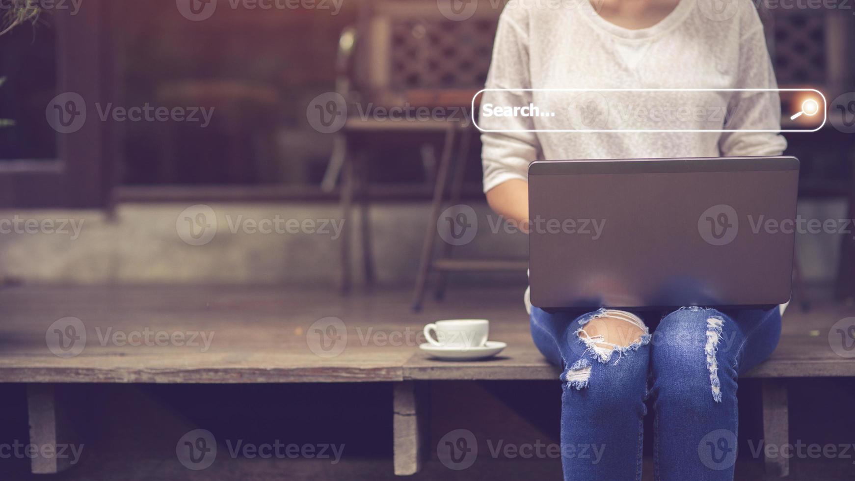 People hand using laptop or computor searching for information in internet online society web with search box icon and copyspace. photo