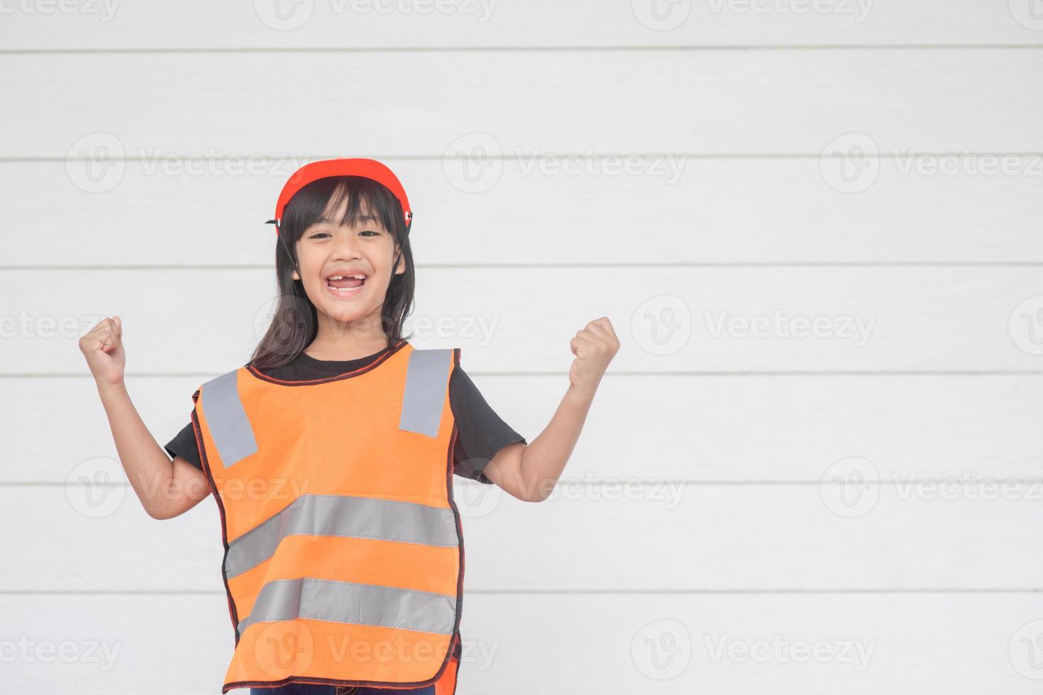 Asian girl children playing as an engineer helmet photo