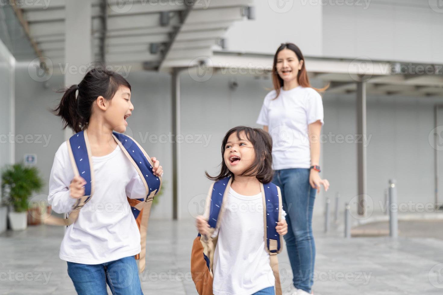 Pupils of school. Girls with backpacks. Beginning of lessons. First day photo