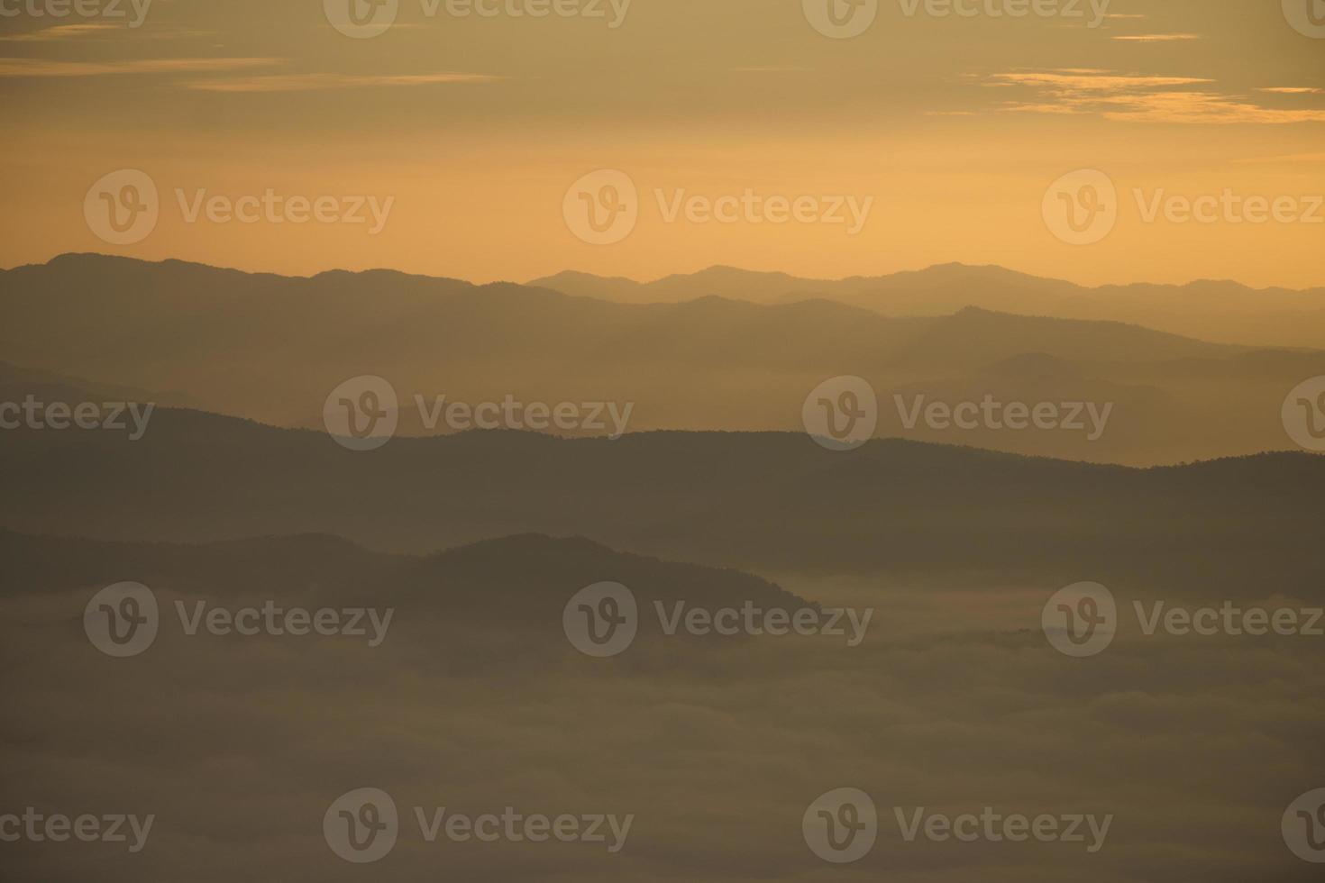 Layer of mountains and mist during sunset photo