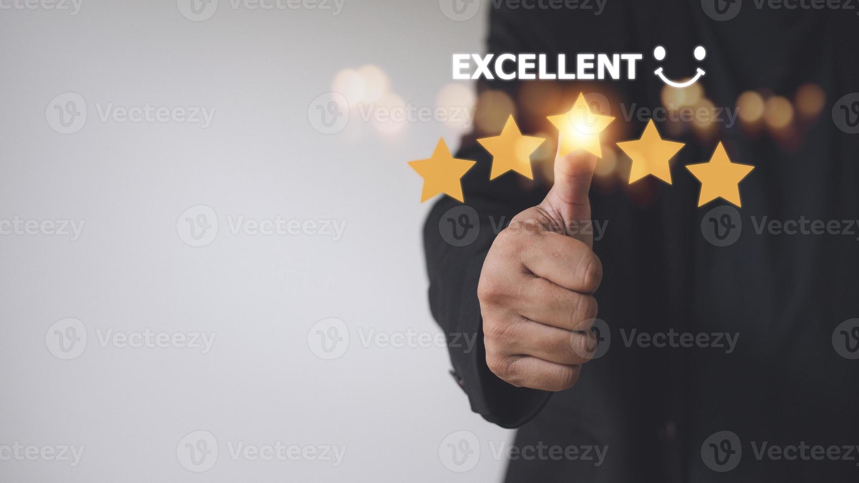 customer hand  with gold five star rating feedback icon and press level excellent rank for giving best score point to review the service, business concept photo