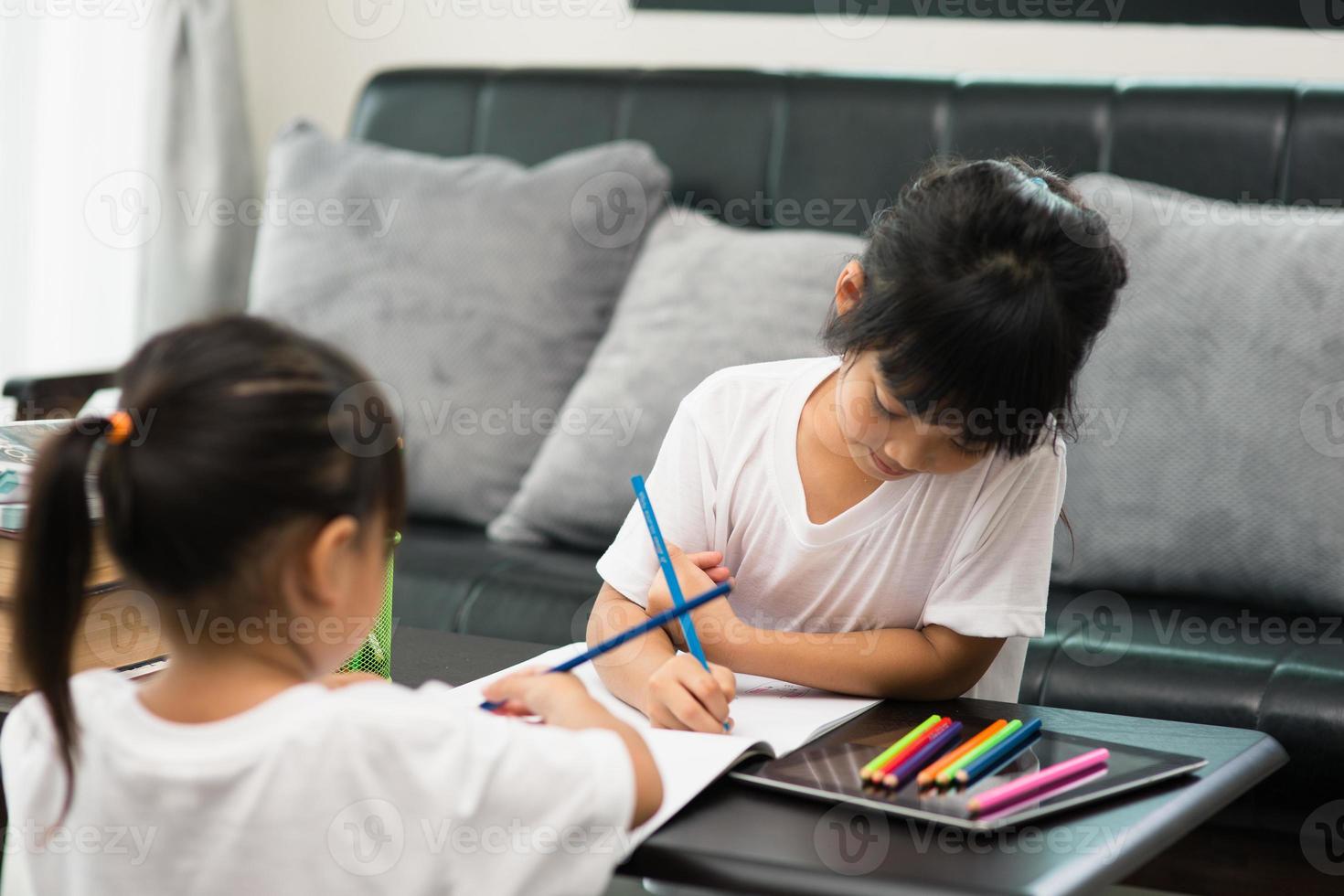 Covid-19 Coronavirus and Learning from home, Home school kid concept. Little children study online learning from home with laptop. photo