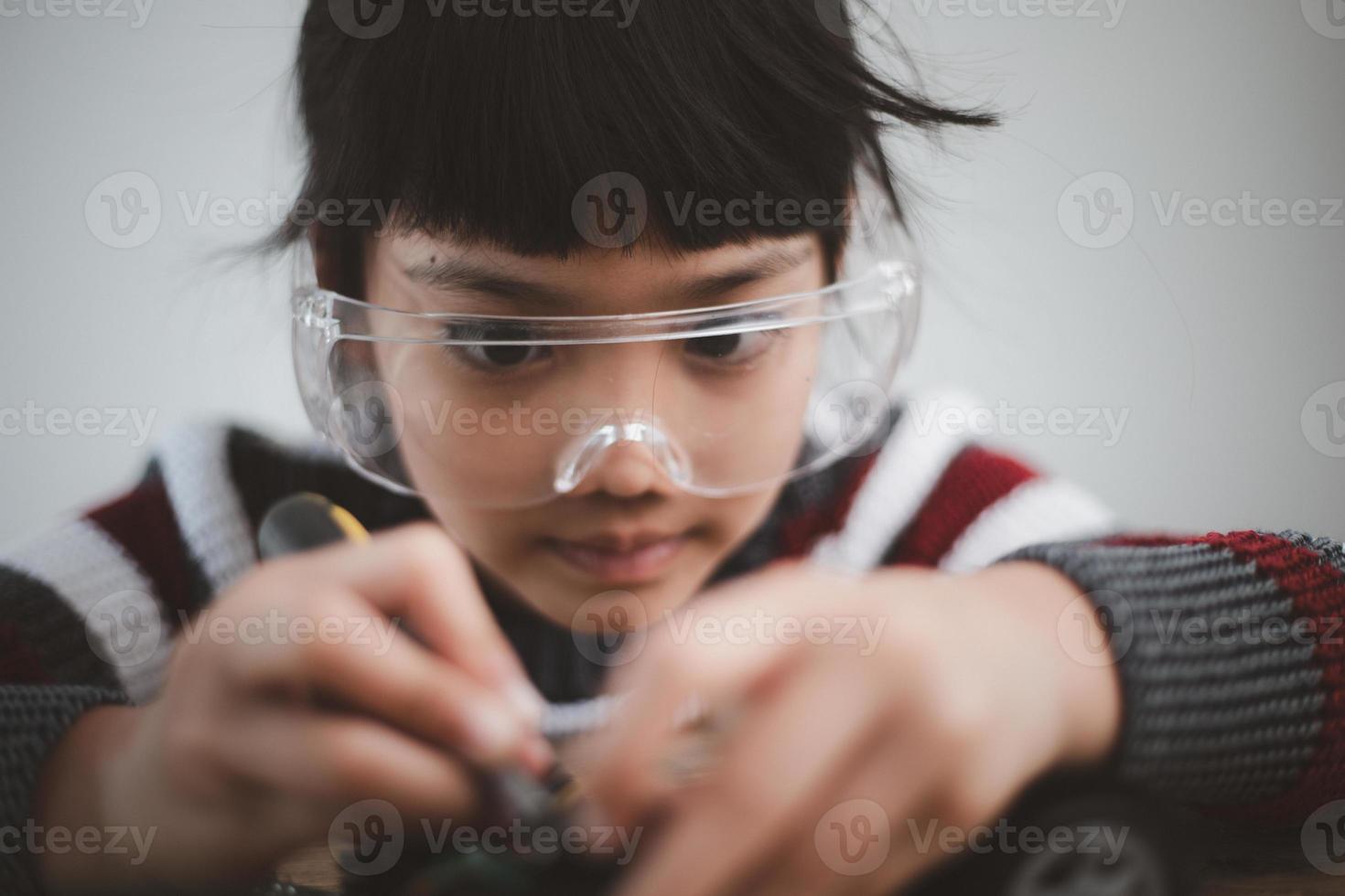 Asia students learn at home in coding robot cars and electronic board cables in STEM, STEAM, mathematics engineering science technology computer code in robotics for kids concept. photo