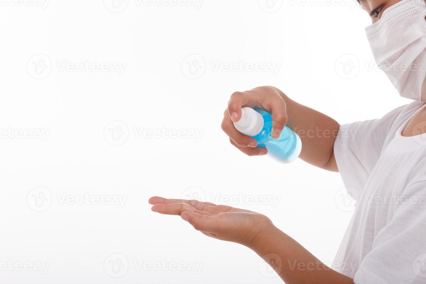little girl using alcohol gel for cleaning hands.on white background photo