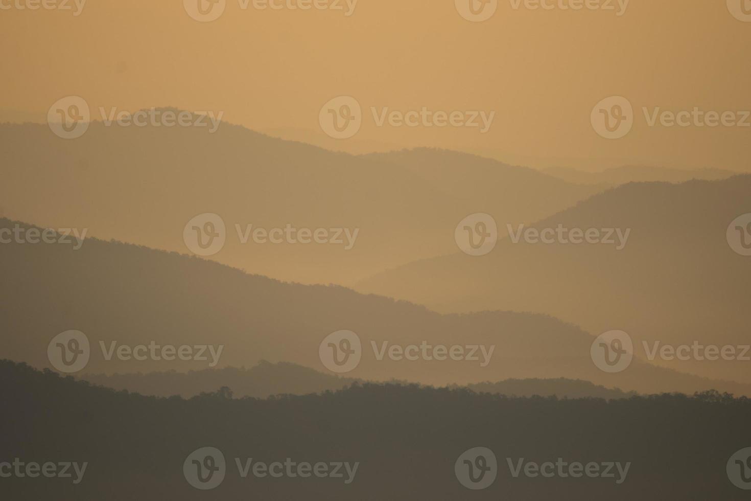 Layer of mountains and mist during sunset photo