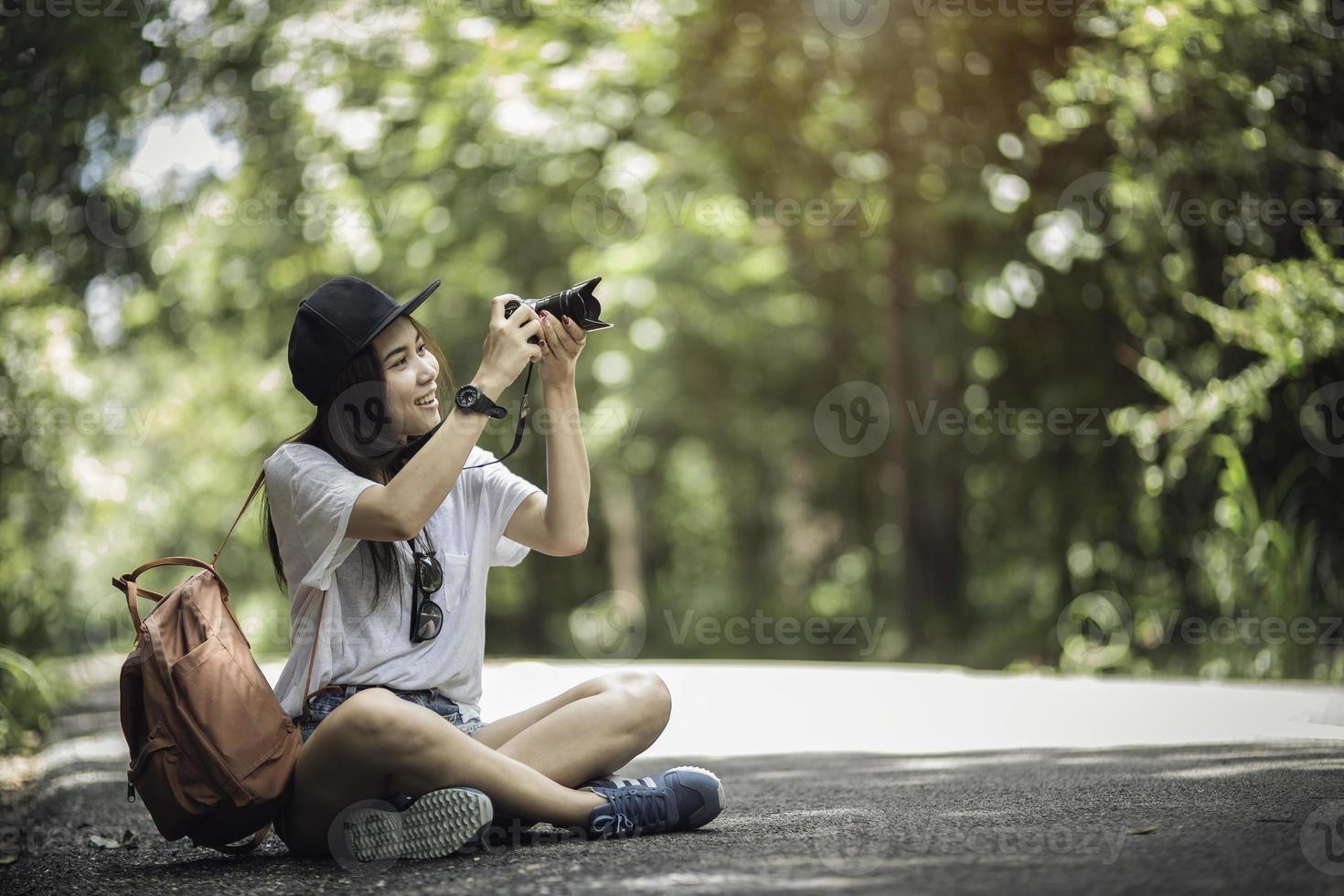Outdoor summer smiling lifestyle portrait of pretty young woman having fun with camera travel photo of photographer Making pictures
