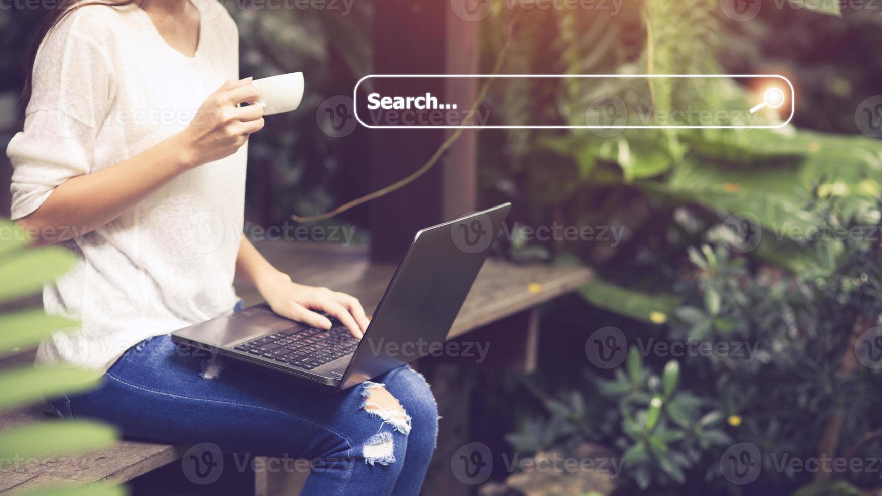 People hand using laptop or computor searching for information in internet online society web with search box icon and copyspace. photo