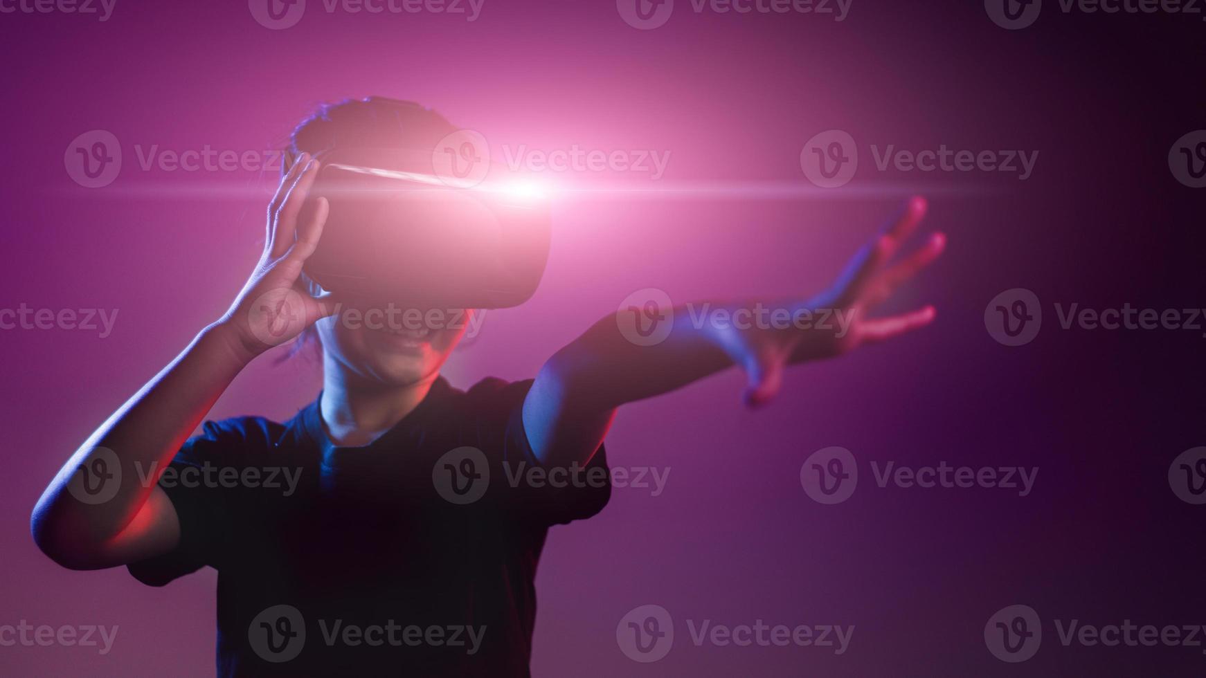 happy girl in glasses of virtual reality. Augmented reality, science, future technology concept. VR. Futuristic 3d glasses with virtual projection. Neon light. photo