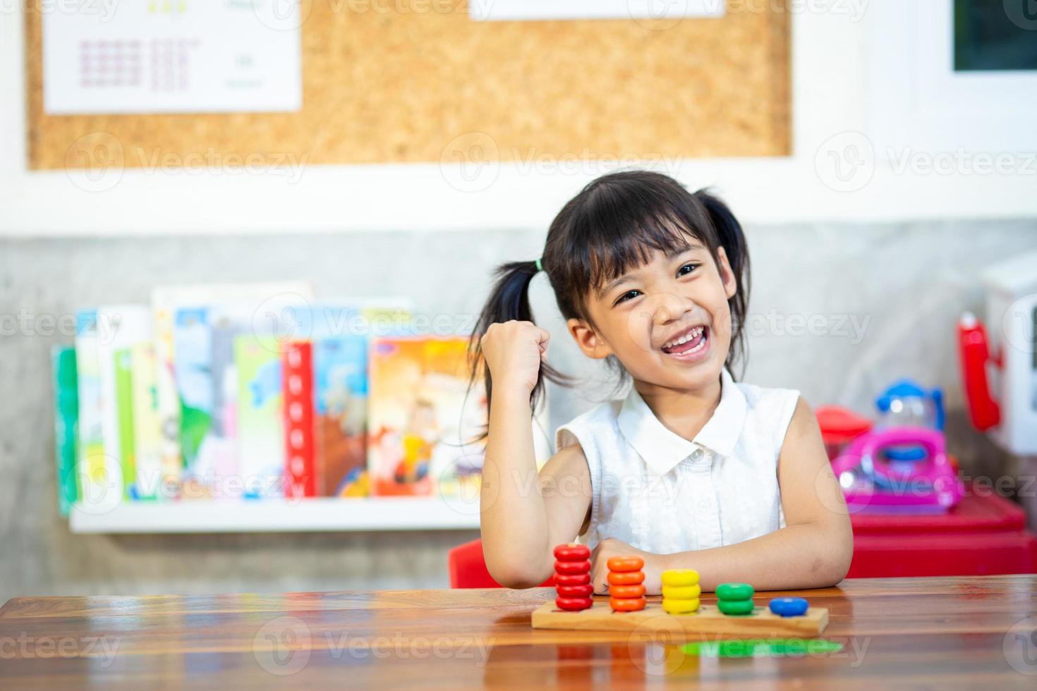 child little girl playing wooden toys photo