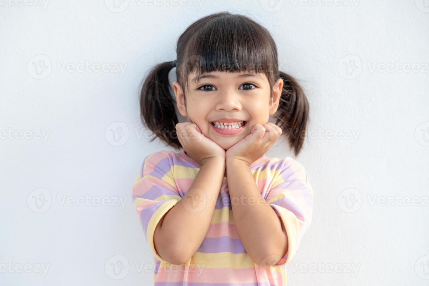 Portrait of happy smiling child girl isolated on white background photo