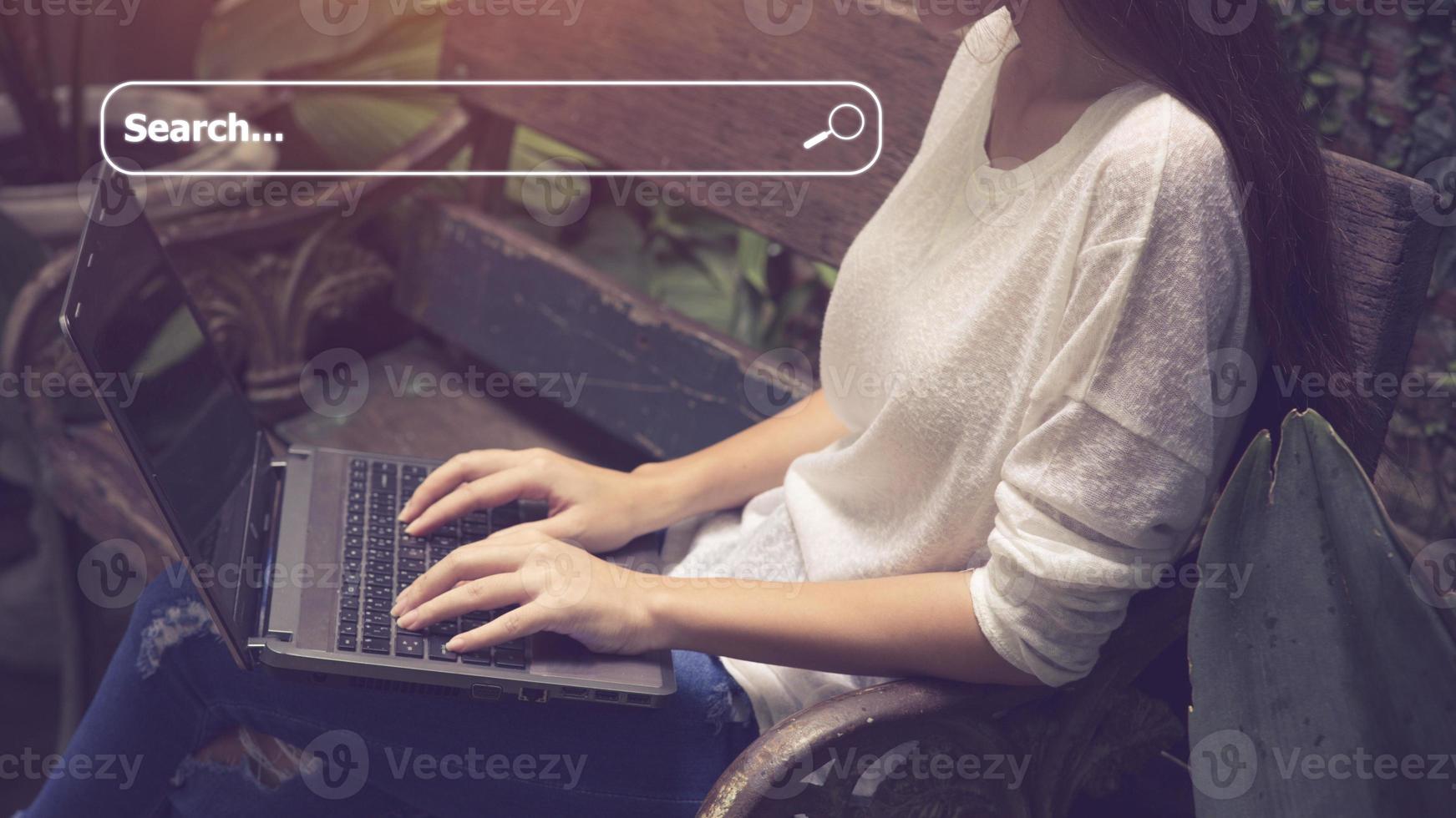 People hand using laptop or computor searching for information in internet online society web with search box icon and copyspace. photo