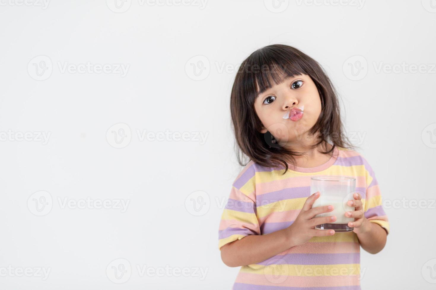 Smiling of Asian girl with a glass of milk photo