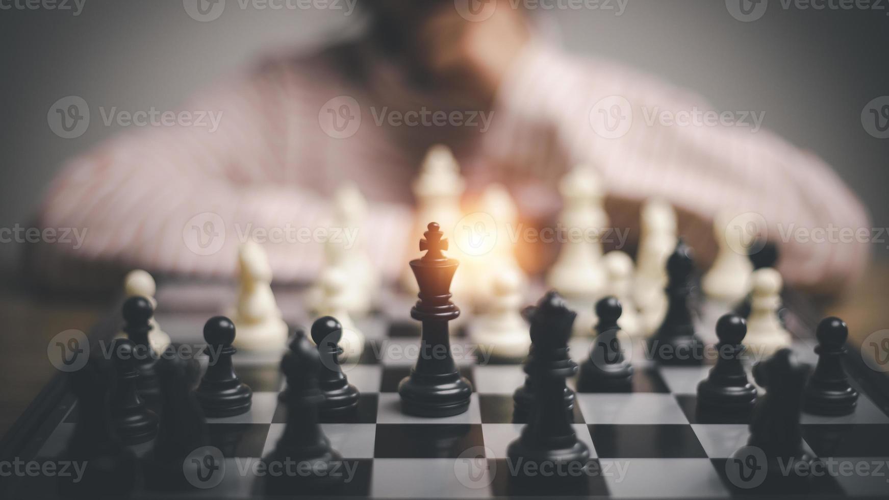 little girl playing a game of chess on a chessboard. photo