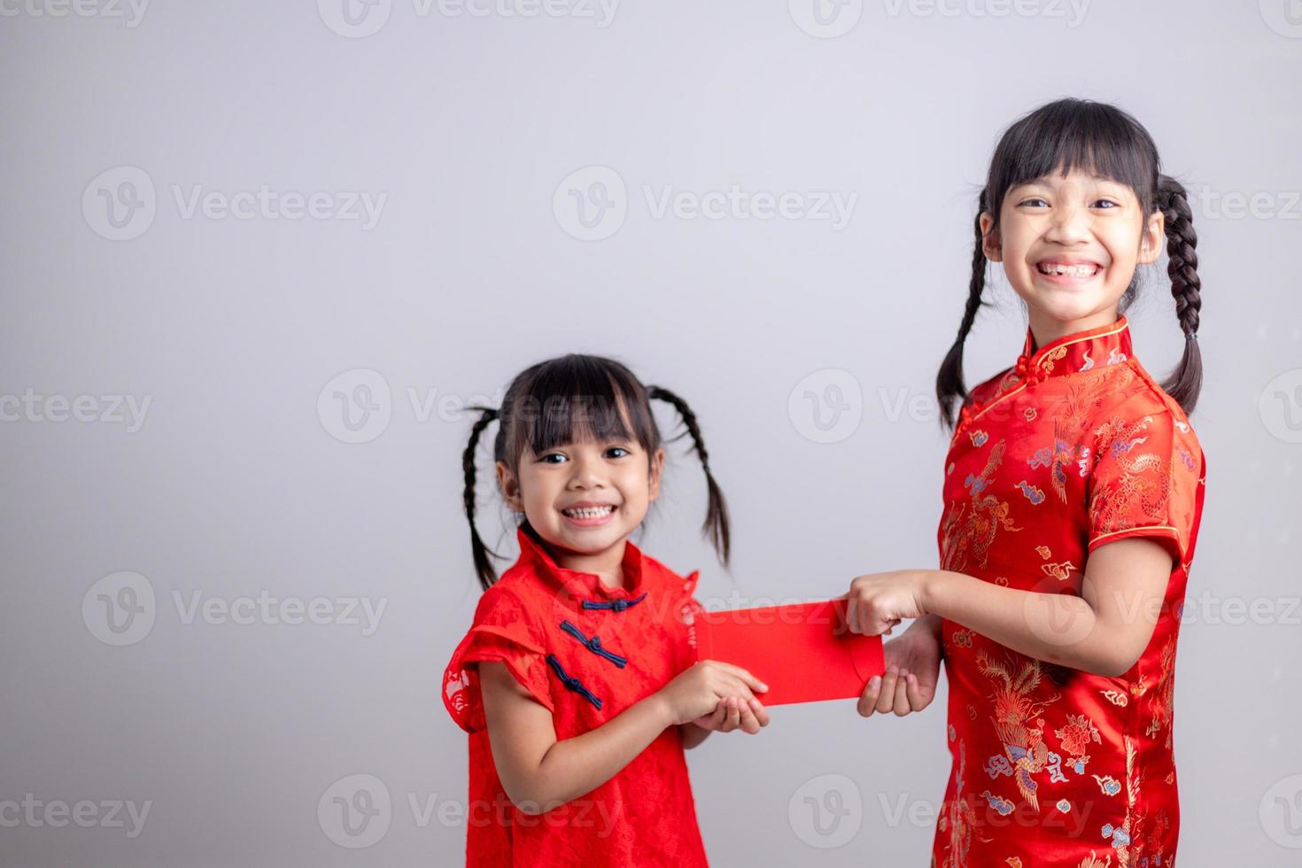 happy asian little girl received red envelope for chinese new year photo