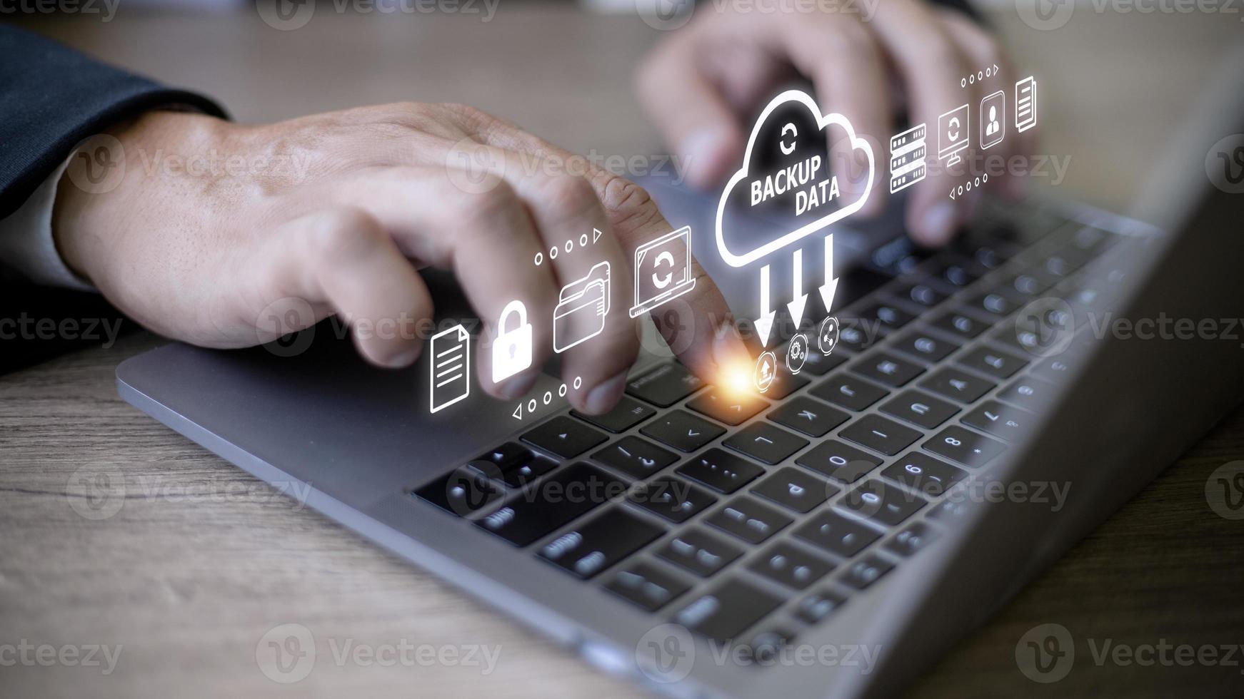 Businessman using a computer to backup storage data Internet technology concept for backup online documentation database and digital file storage system or software,file access, doc sharing. photo