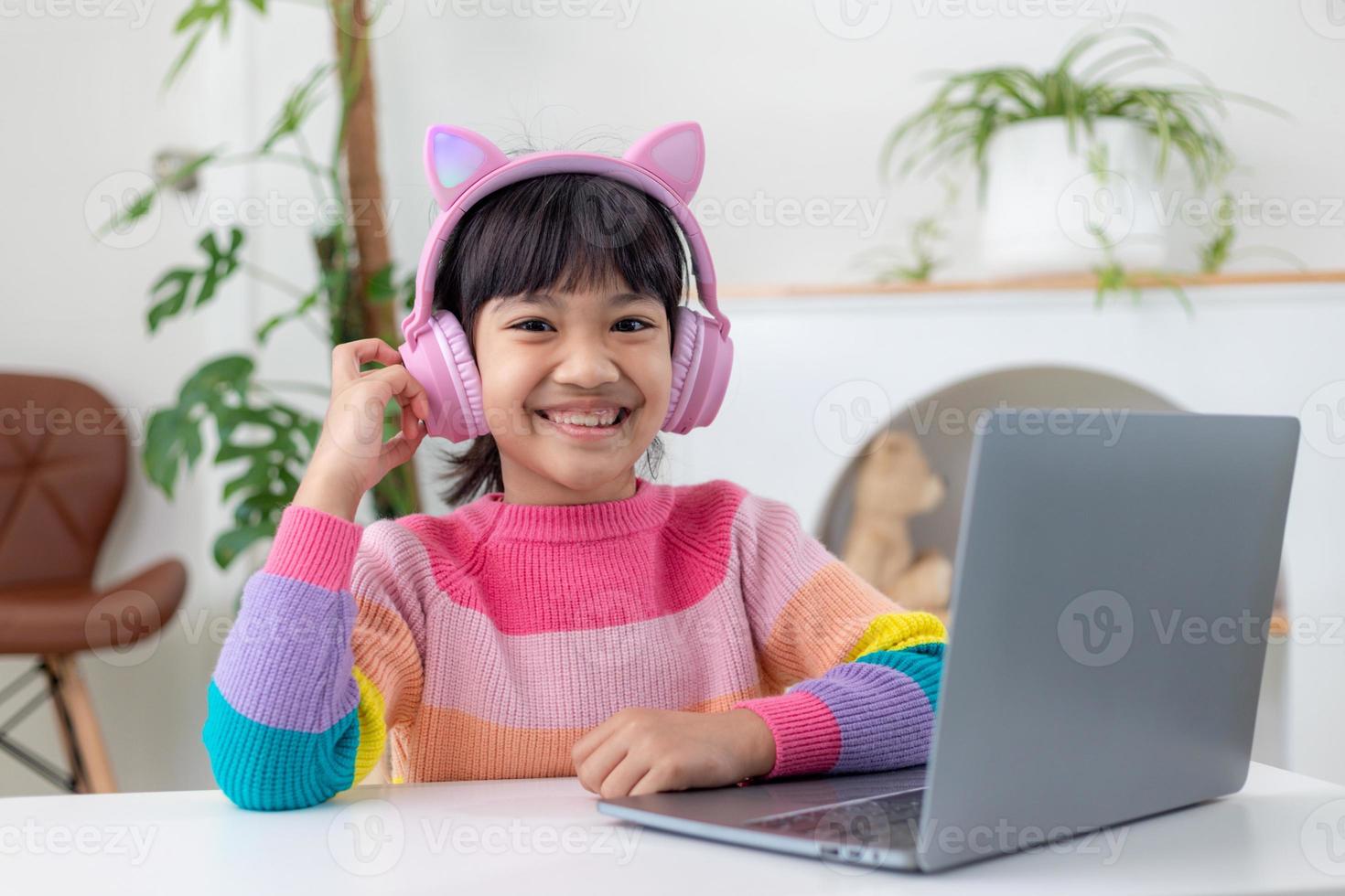 Asian girl using Laptop computer for online study homeschooling during home quarantine. homeschooling, online study, home quarantine, online learning, corona virus or education technology concept photo