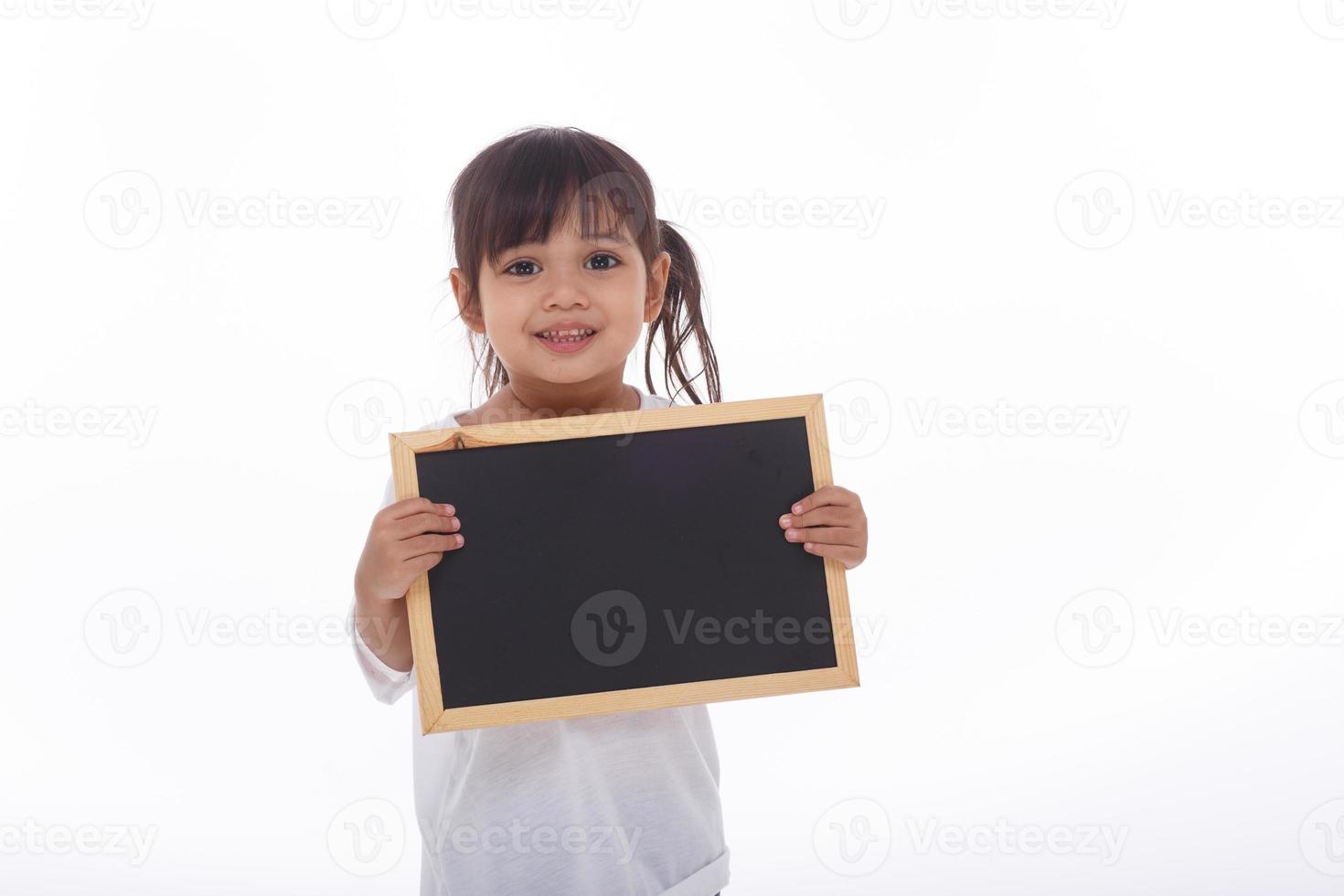 little Asian child show the black board on isolated background photo