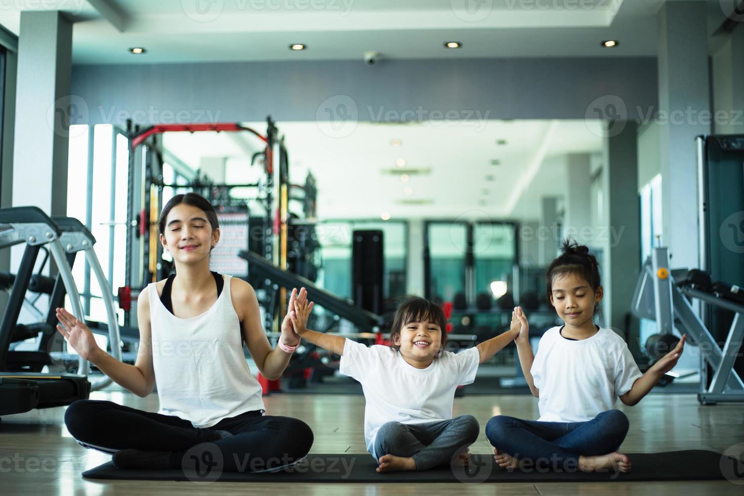 Group of children doing gymnastic exercises photo