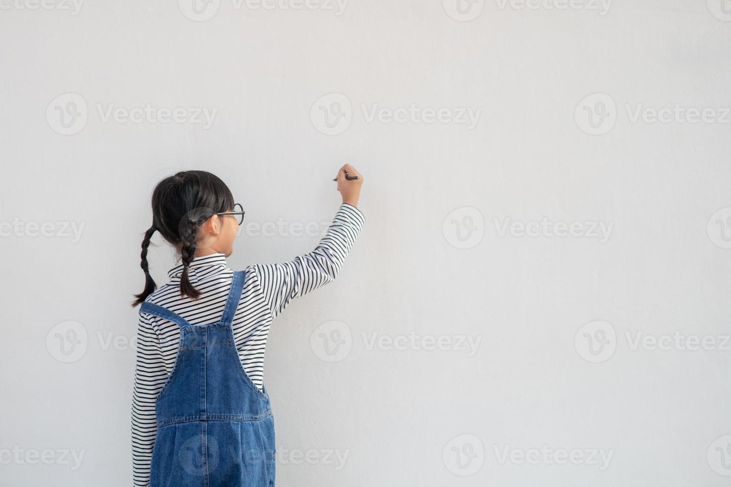 Little children painting on white wall photo