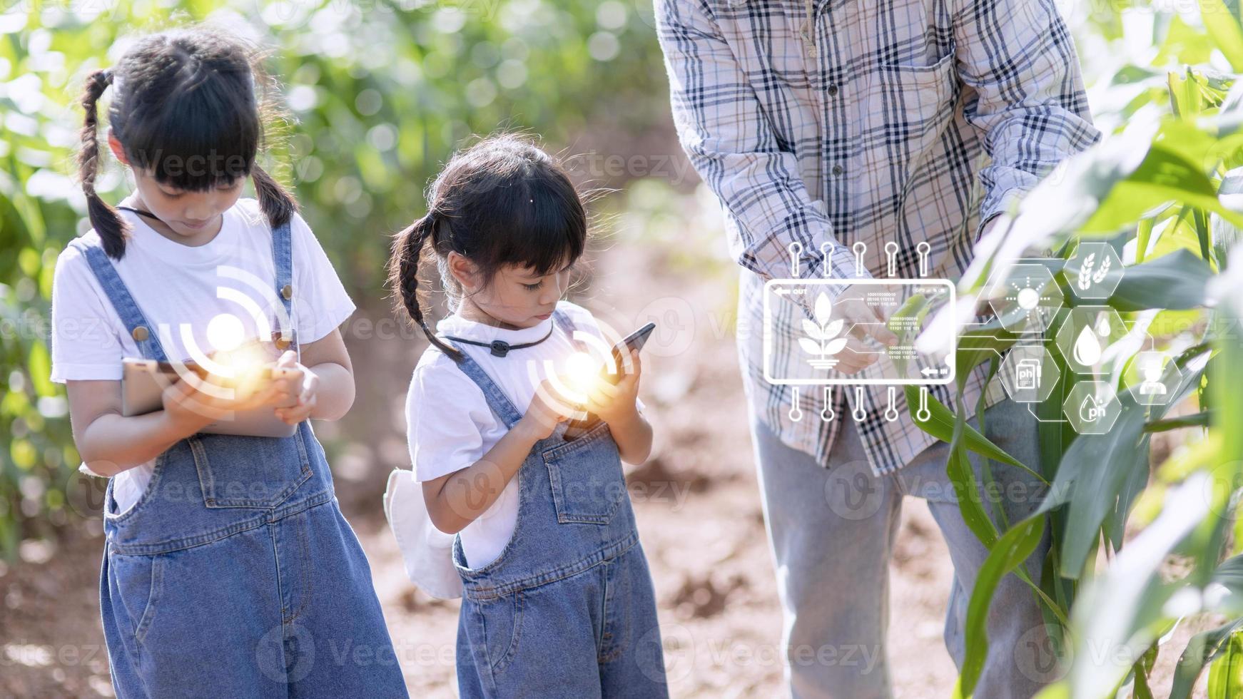 The little girl uses a tablet to analyze the growth of plants in the agricultural plot and visual icon., the agricultural technology concept. smart farming learning Concept photo