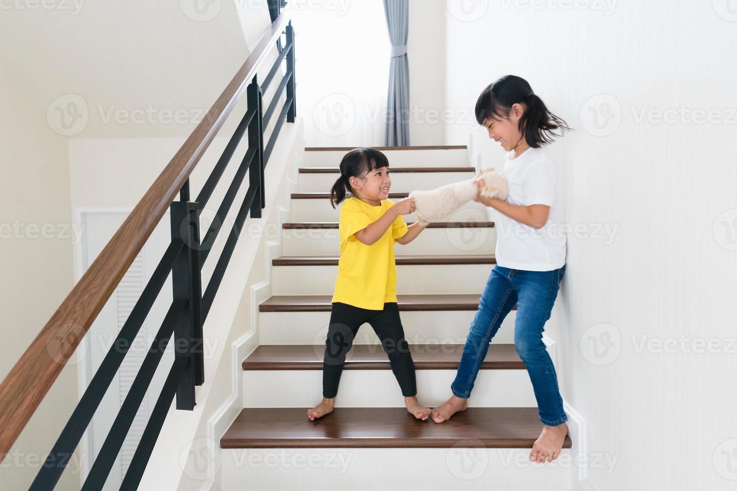 two little girl fighting over bear photo