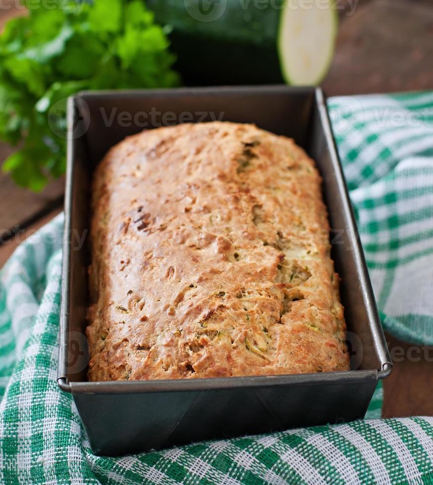 Zucchini bread with cheese on a wooden background photo