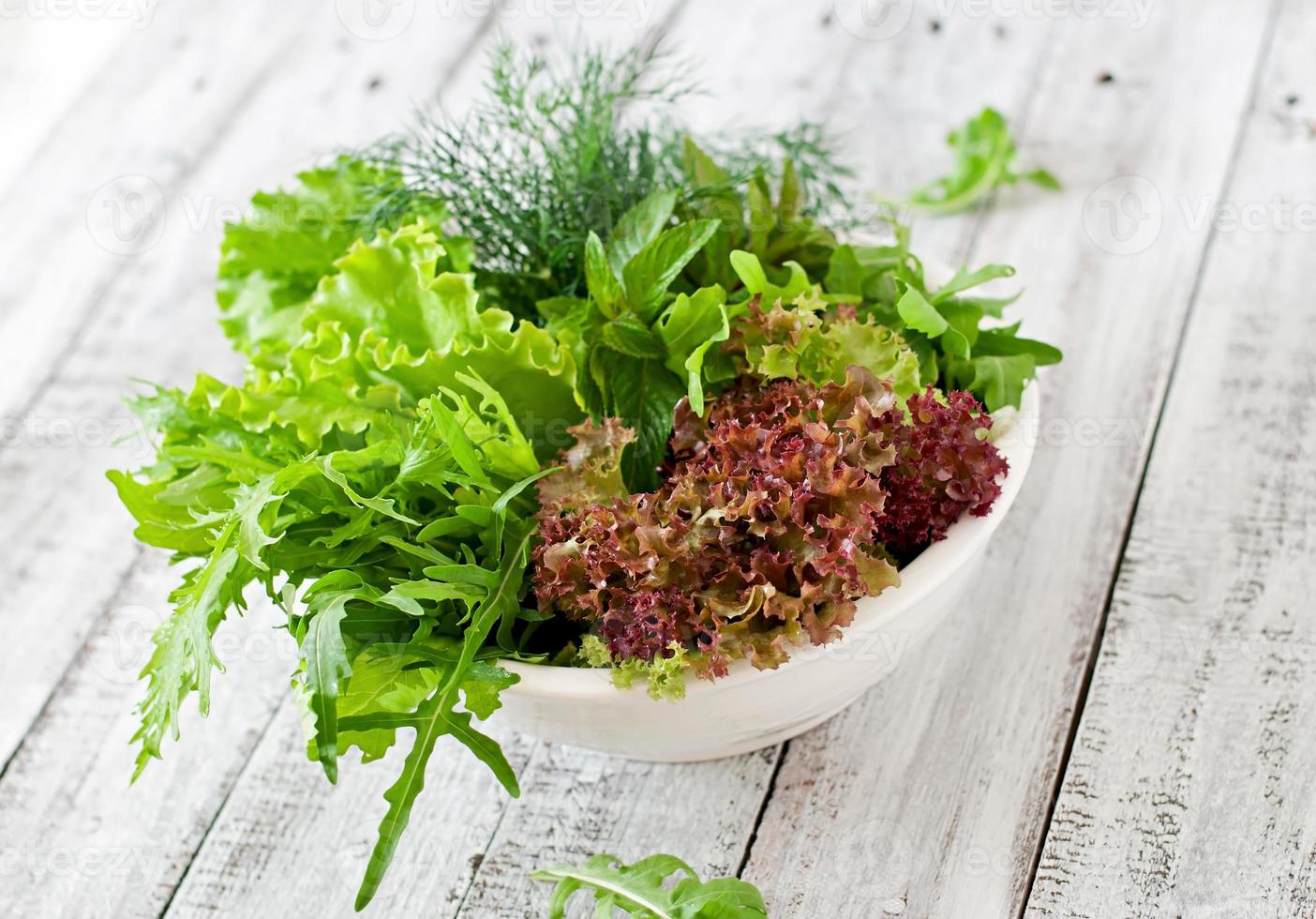 Variety fresh organic herbs  on wooden background in rustic style photo