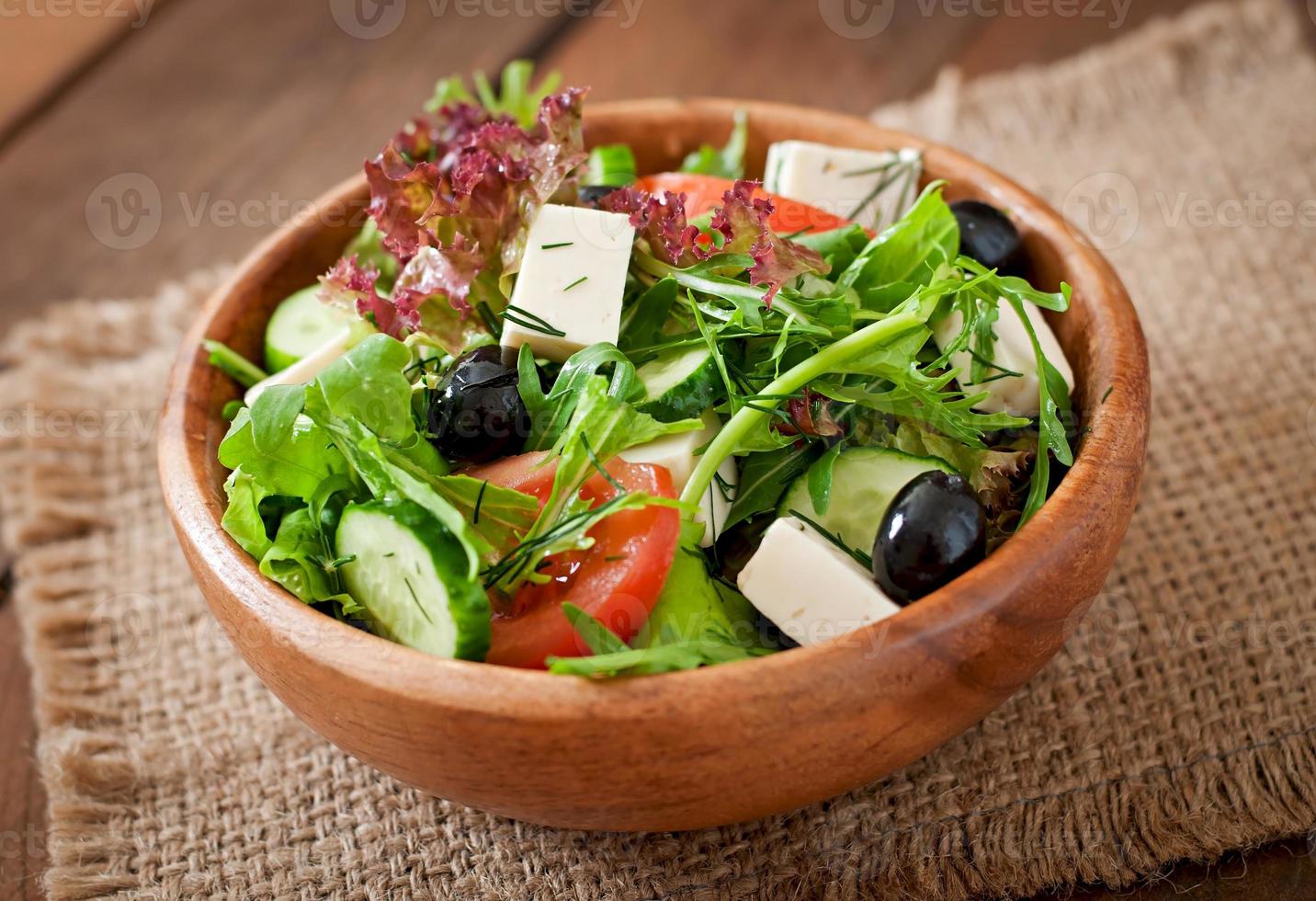 Very useful and diet salad of herbs, vegetables and feta cheese photo