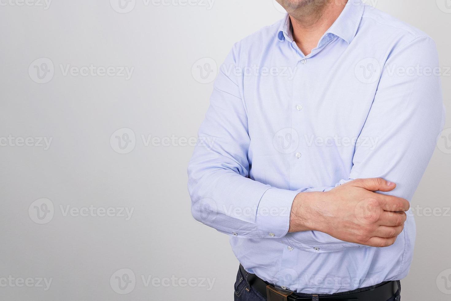 Business man without a face in a shirt on a light background photo