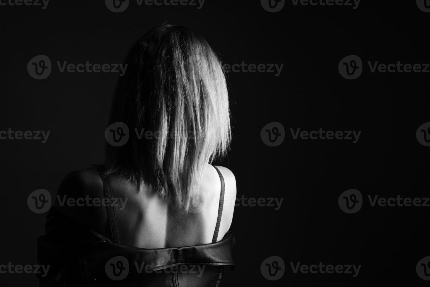 Portrait of a woman in a leather jacket and lingerie, black and white photo