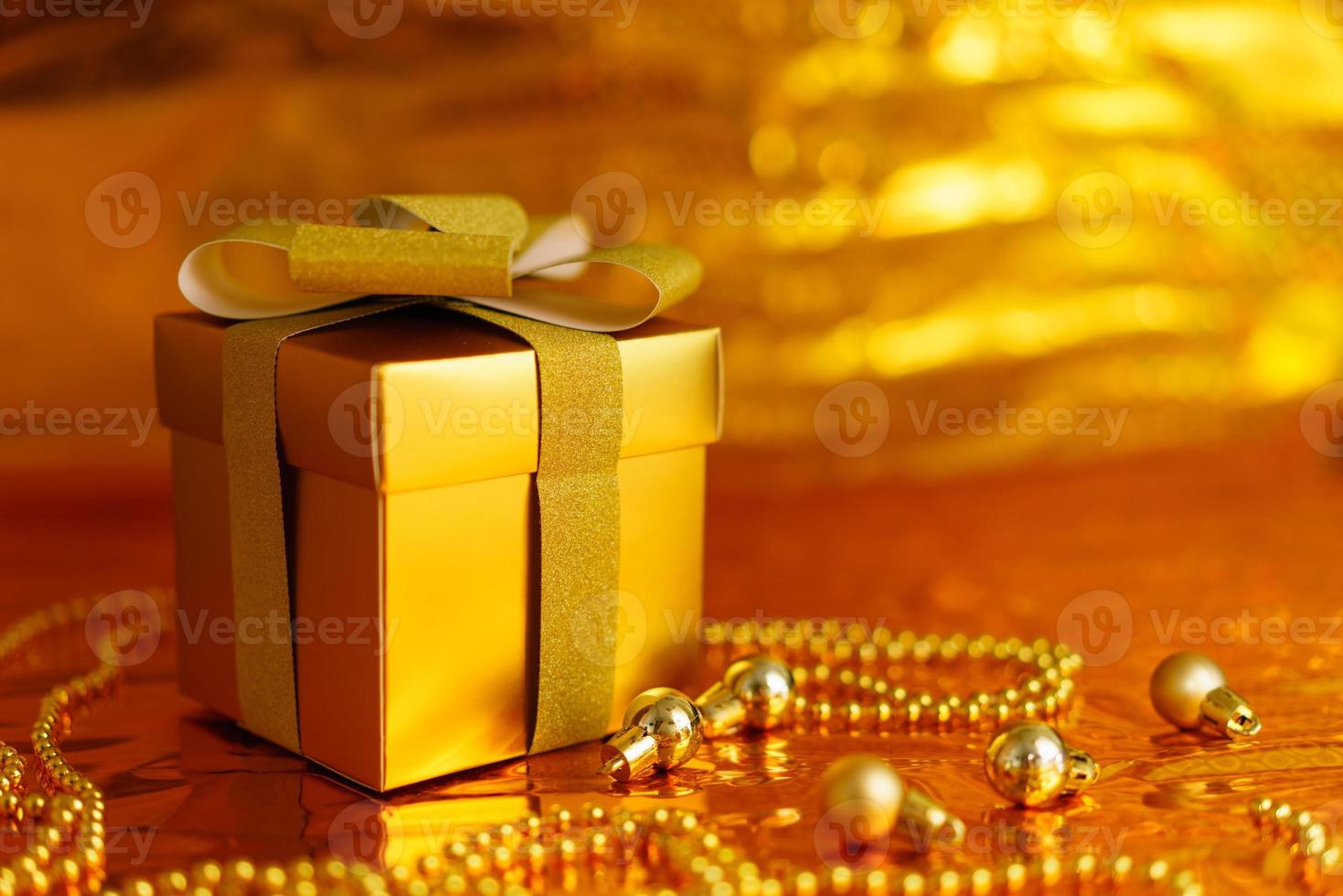 golden gift box on shiny background photo