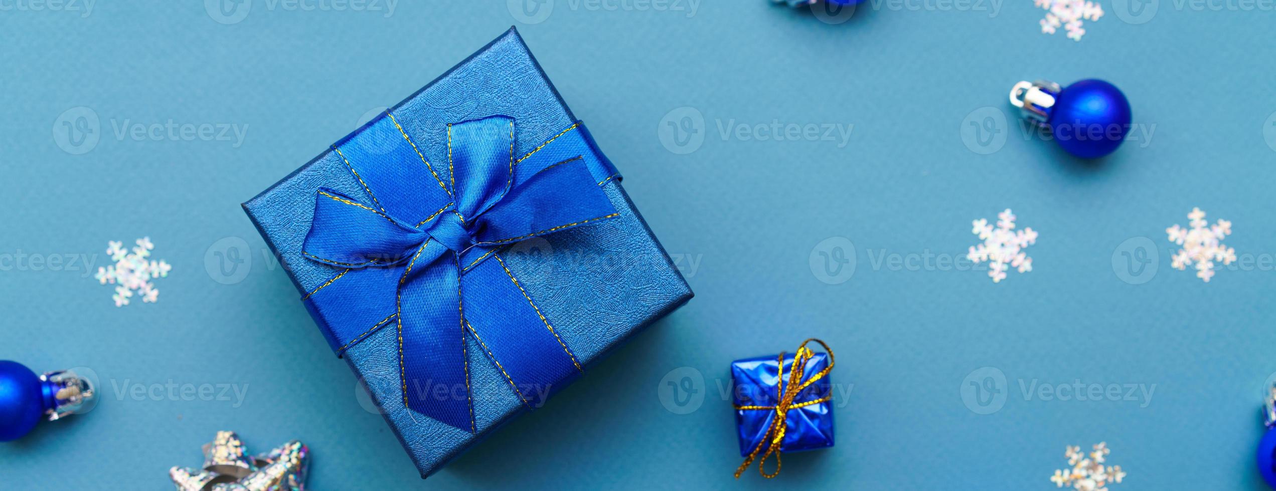 Gift paper box banner with blue ribbon bow and dark blue christmas balls photo