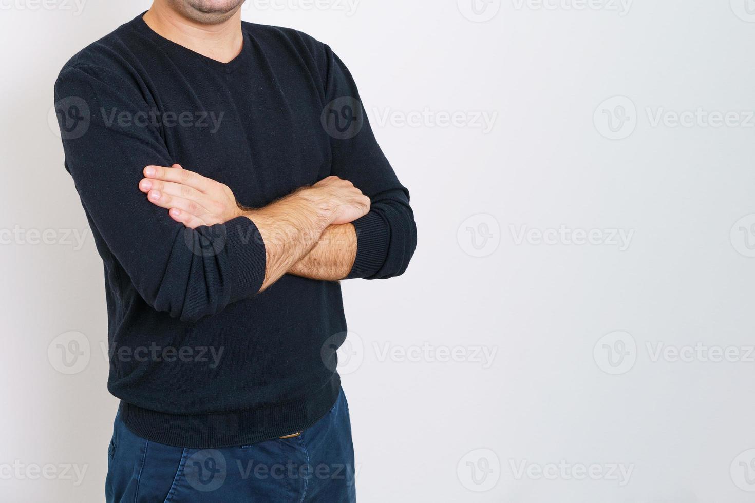 Business man employer arms crossed in dark clothes on gray background. photo