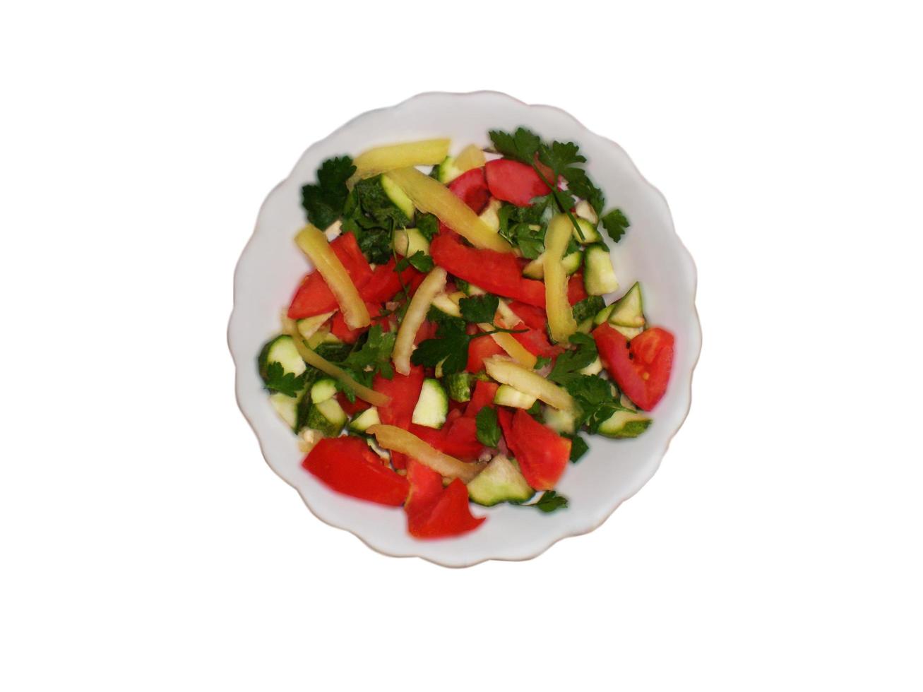 Vegetable salad with cucumber, tomato, parsley, onion, garlic and sweet pepper on a white background photo