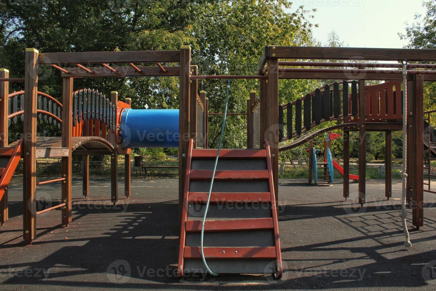 Wooden modern ecological safety children outdoor playground equipment in public park. Nature architecture construction playhouse in city. Children rest and childhood concept. Idea for games on air. photo