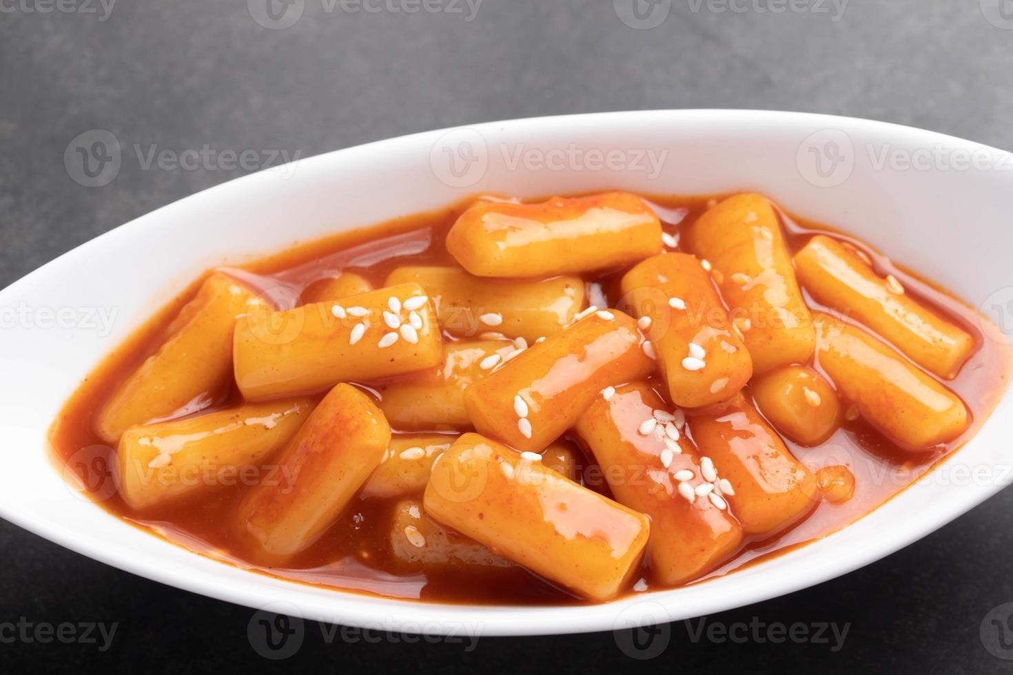 deep fried Korean rice cake tteokbokki Spicy tteokbokki Korean style food in a white cup. photo