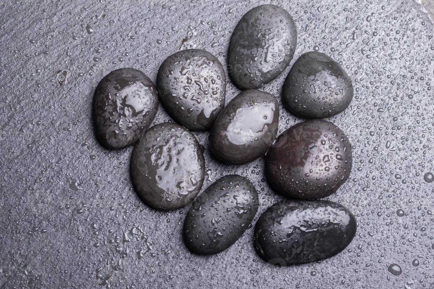 Black pebbles for texture for background stones or rocks and water drops. photo