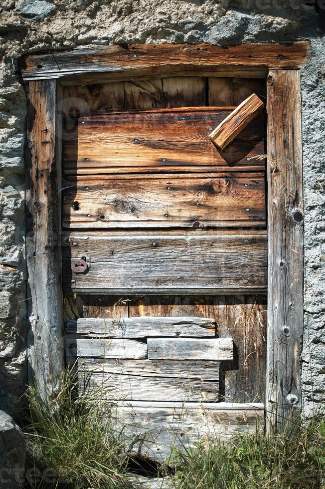 antigua puerta de madera en cabaña alpina foto