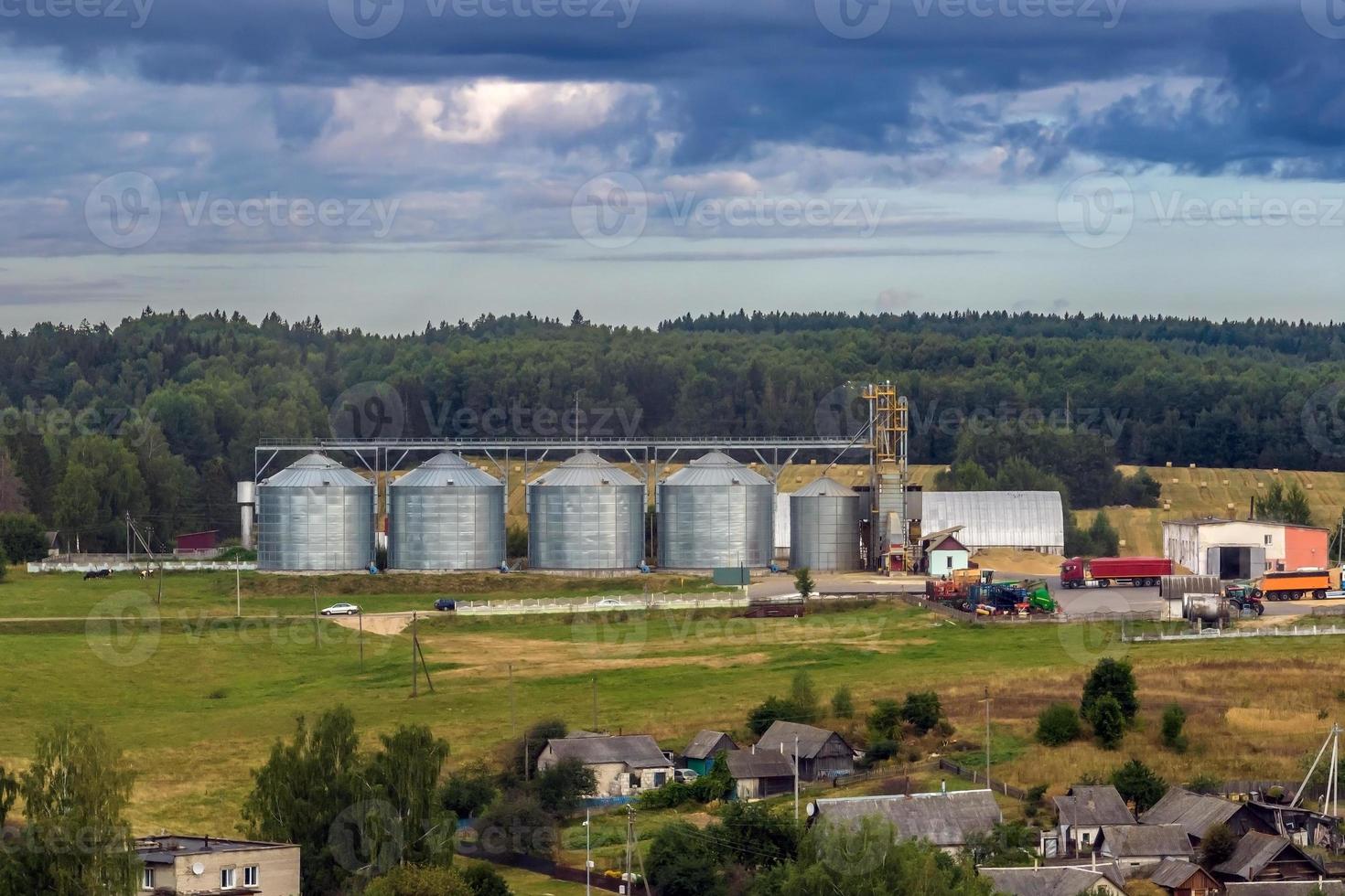 agro silos granary elevator with seeds cleaning line on agro-processing manufacturing plant for processing drying cleaning and storage of agricultural products photo
